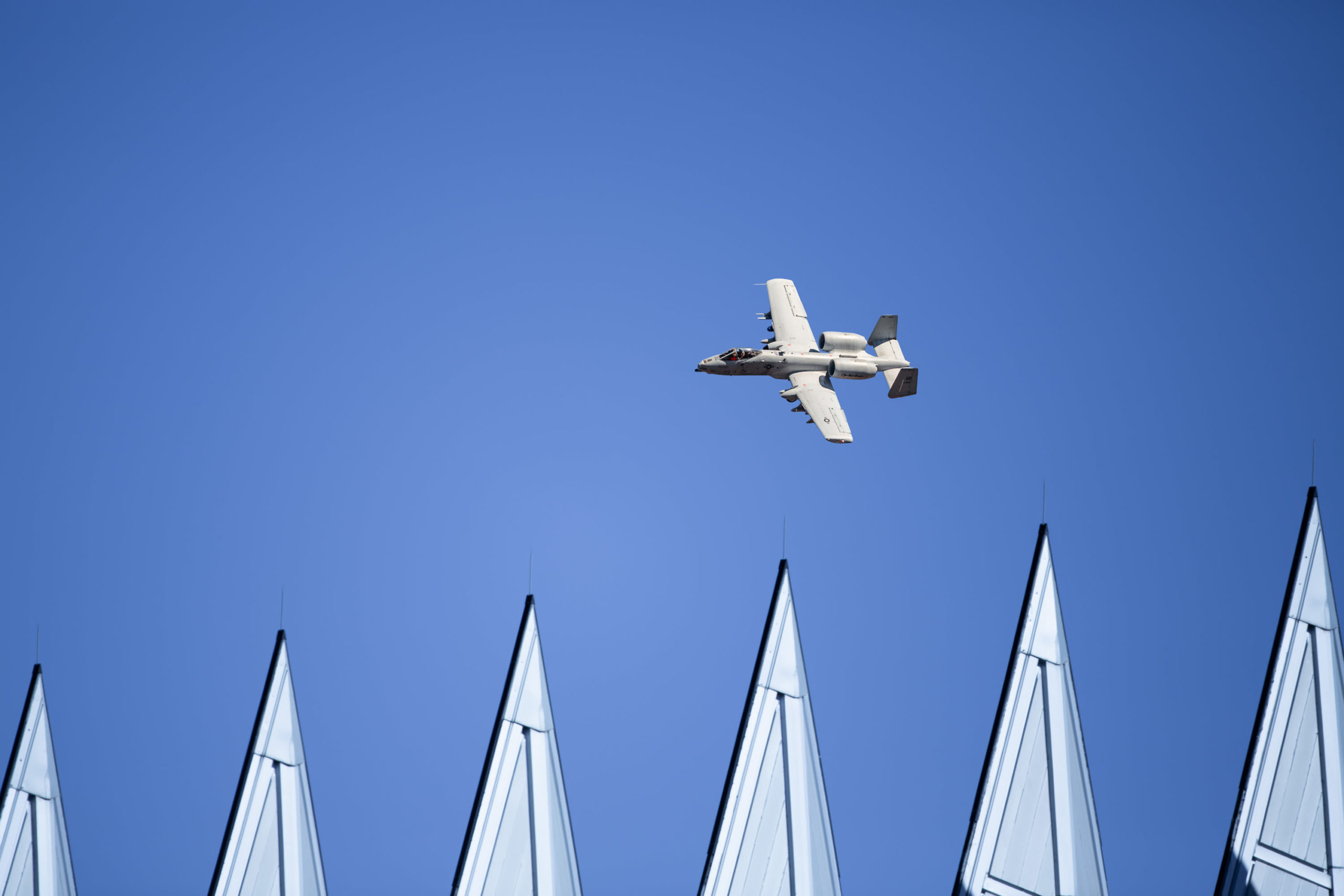 A jet flying in a blue sky.