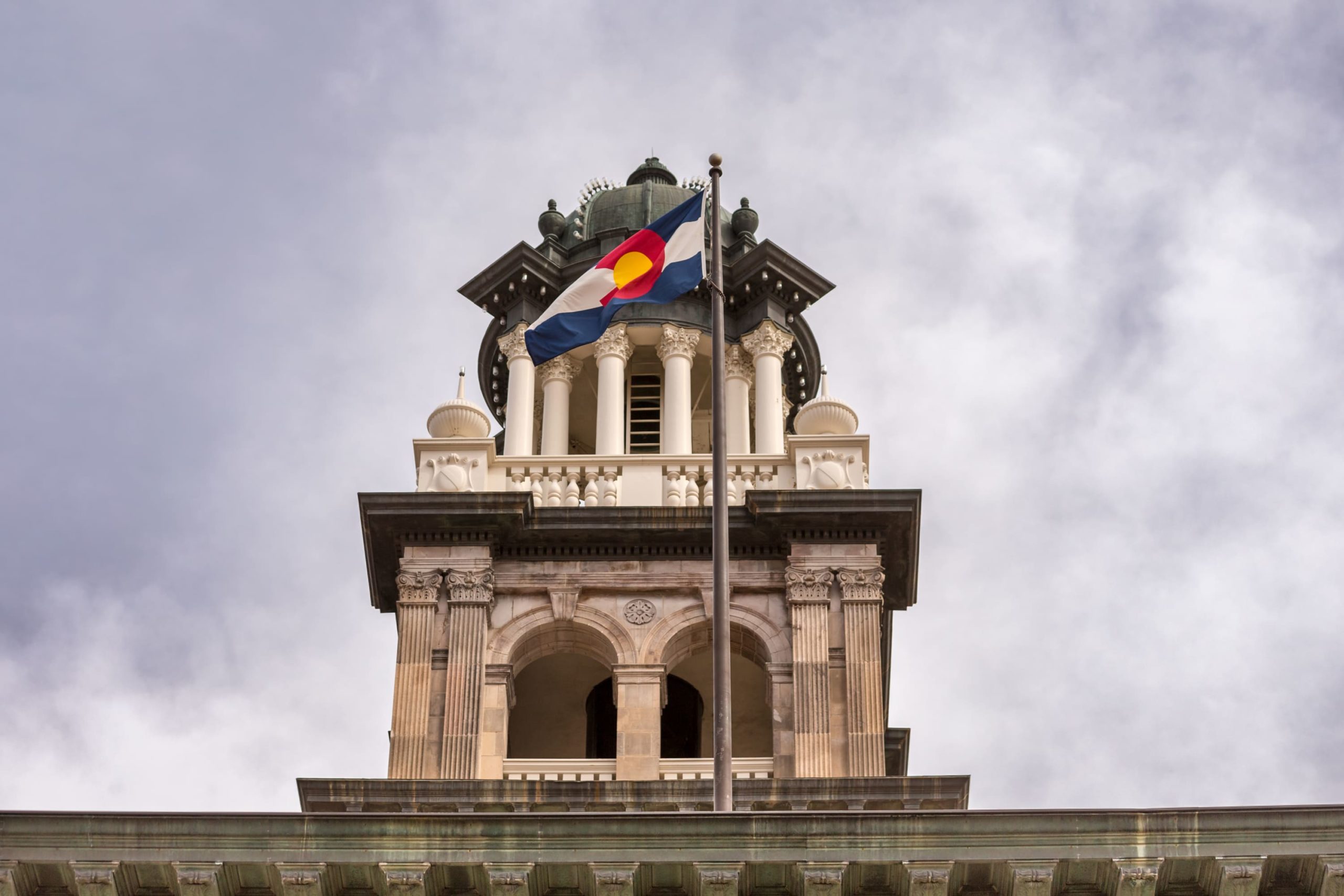 Colorado flag flies in front of a building.