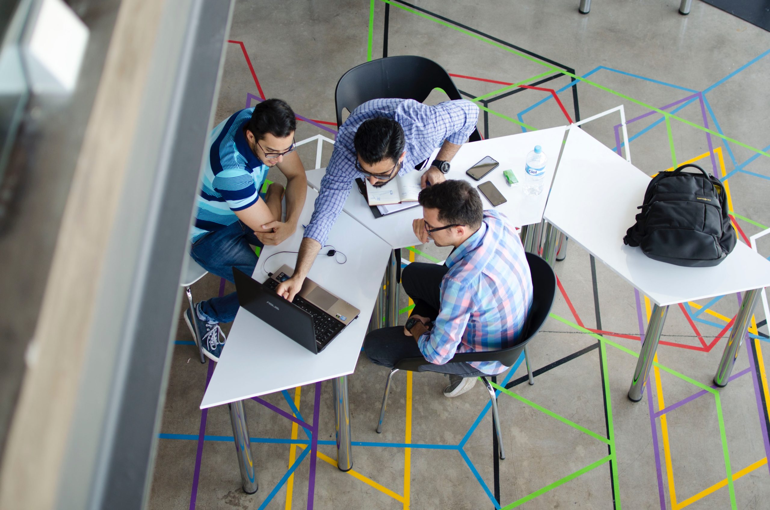 A group of people work together at a table.